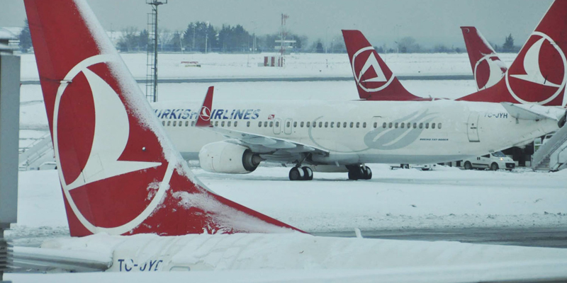 Turkish Airlines aircrafts are stationed at Ataturk International Airport covered in snow, in Istanbul, Tuesday, Jan. 10, 2017. Heavy snow continued to clog roads, shipping traffic in Bosphorus and forced hundreds of flight cancellations in the Turkish metropolis. (Faik Kaptan/Depo Photos via AP)