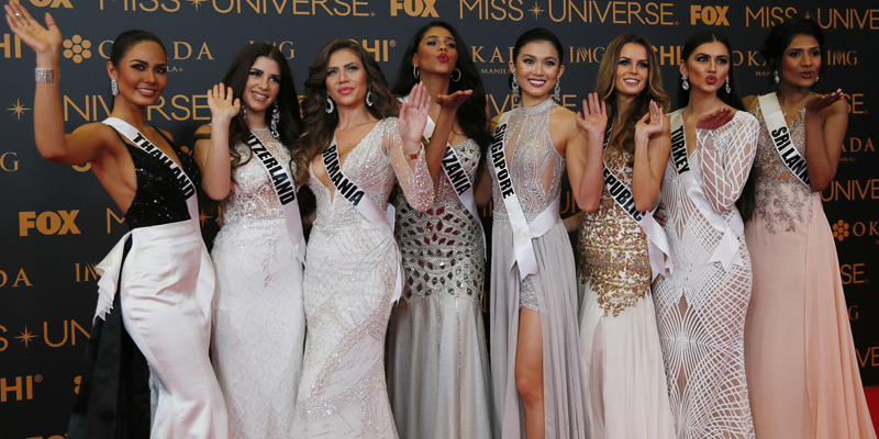 Miss Universe contestants blow kisses to photographers as they pose on the red carpet on the eve of their coronation Sunday, Jan. 29, 2017, at Philippines. Photo Features