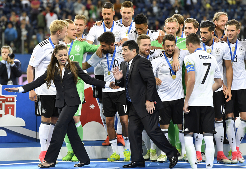 Soccer legend Diego Maradona leaves the podium before the trophy is awarded after Germany won 1-0 in the Confederations Cup final soccer match between Chile and Germany, at the St.Petersburg Stadium, Russia, Sunday July 2, 2017. (AP Photo/Martin Meissner)