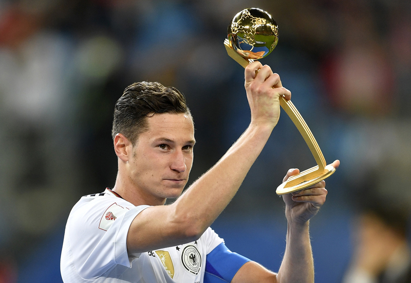 Germany's Julian Draxler holds the Golden Ball best player award after Germany won 1-0 in the Confederations Cup final soccer match between Chile and Germany, at the St.Petersburg Stadium, Russia, Sunday July 2, 2017. (AP Photo/Martin Meissner)