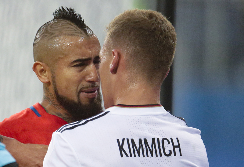 Chile's Arturo Vidal faces Germany's Joshua Kimmich, right, during the Confederations Cup final soccer match between Chile and Germany, at the St.Petersburg Stadium, Russia, Sunday July 2, 2017. (AP Photo/Ivan Sekretarev)