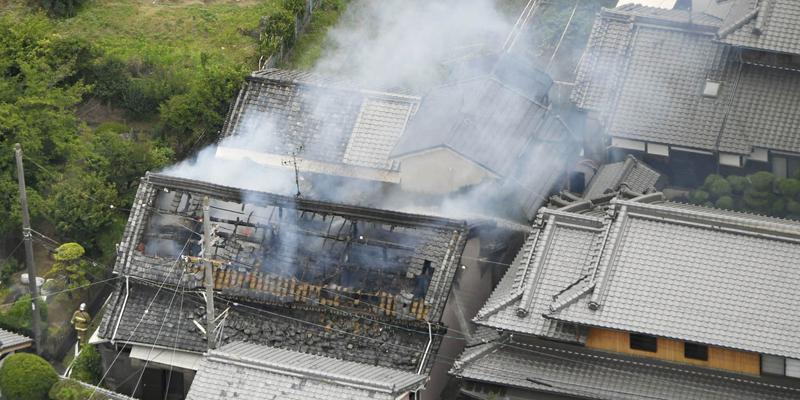 Smoke rises from a house blaze in Takatsuki, Osaka, following an earthquake Monday, June 18, 2018. A strong earthquake shook the city of Osaka in western Japan on Monday morning, causing scattered damage including broken glass and partial building collapses. There were no immediate reports of injuries. (Kyodo News via AP)