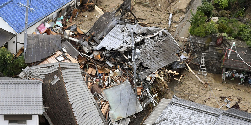 Residential buildings are damaged by a landslide caused by heavy rains in Sakacho, Hiroshima prefecture, south western Japan, Saturday, July 7, 2018.